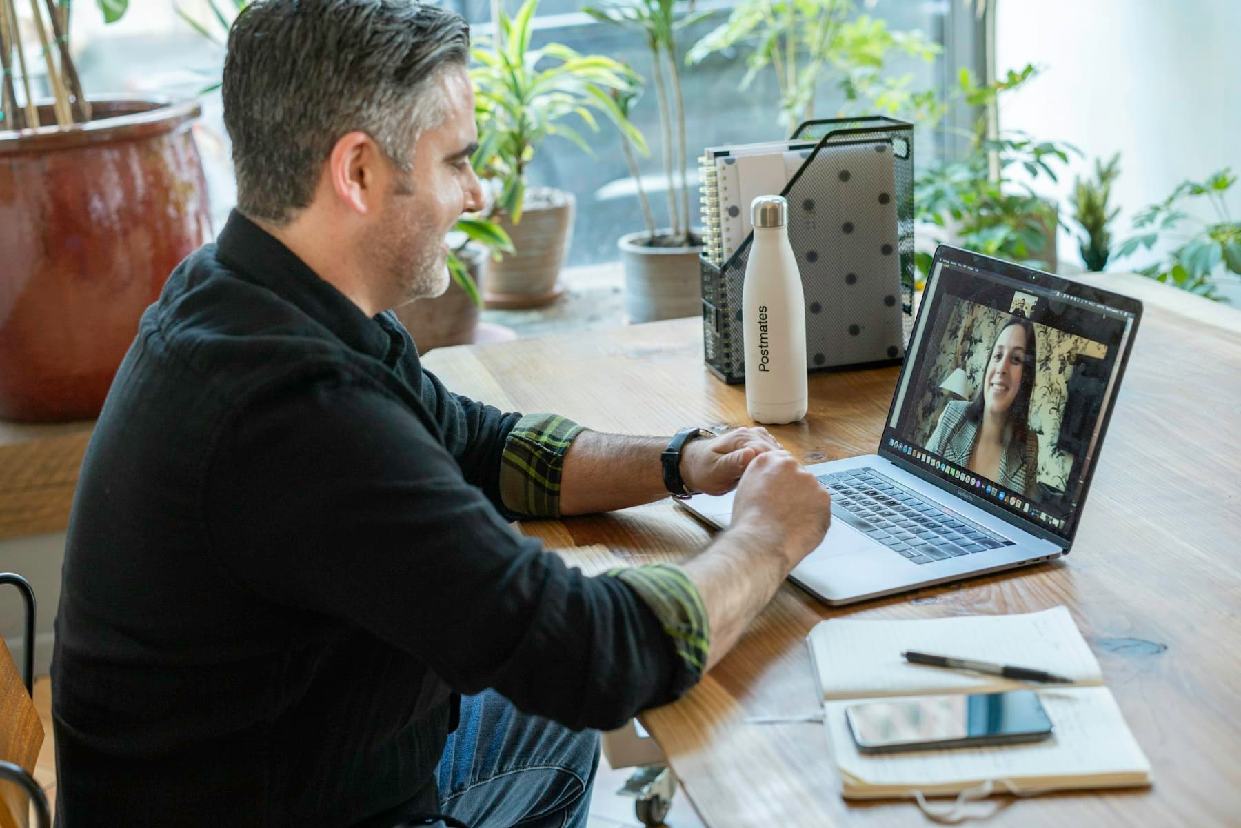 A man on a video call at his desk